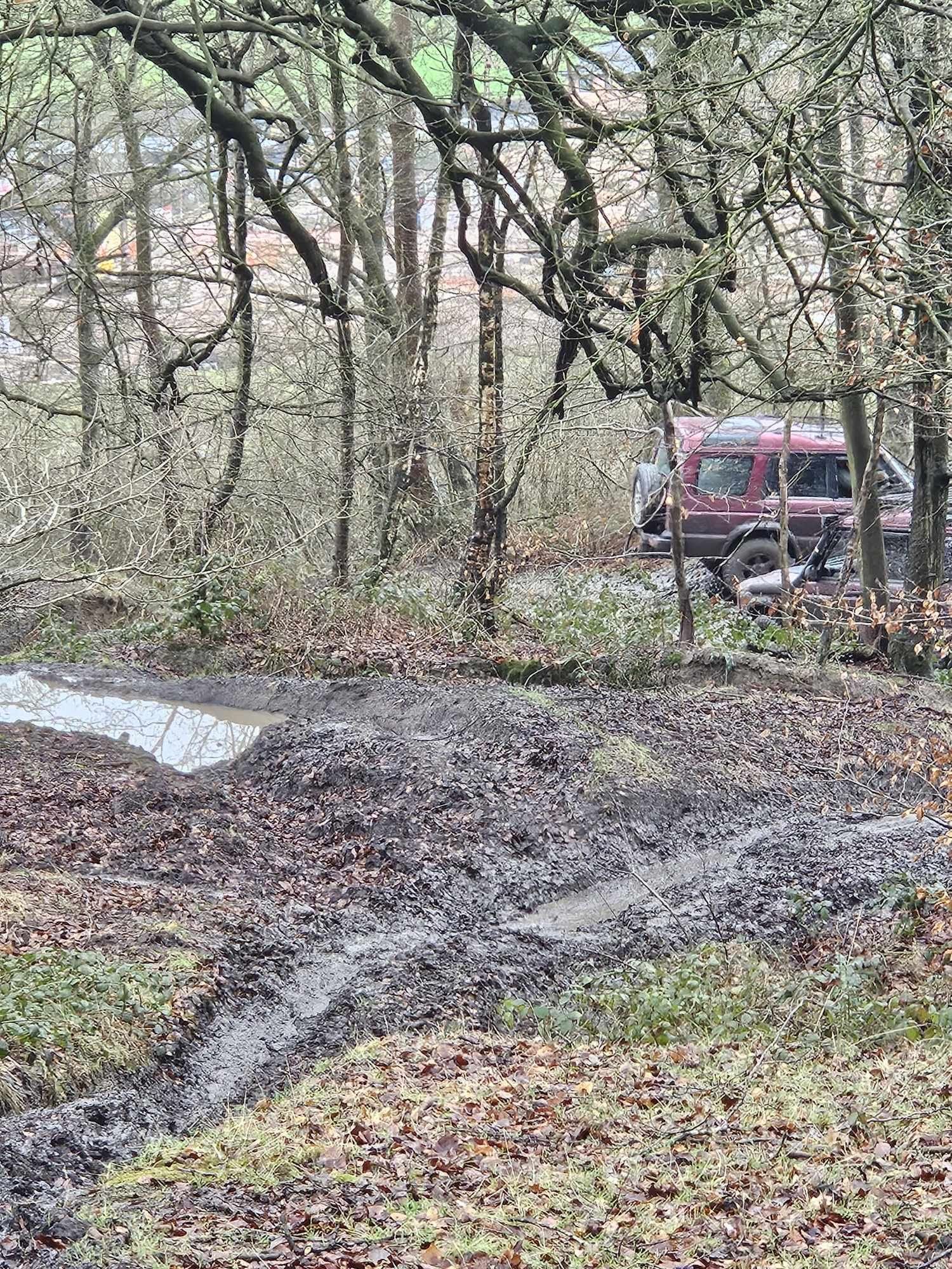Off-road vehicle beyond a muddy woodland training route