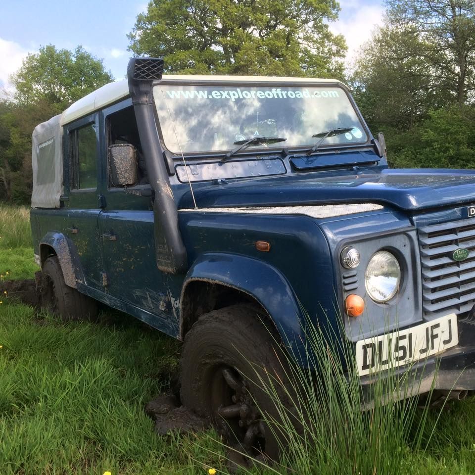 Blue Defender with raised air intake parked on grass