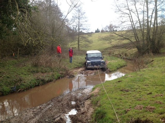 Defender approaching a water-filled off-road crossing